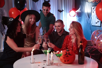 Group of friends having Halloween party at home