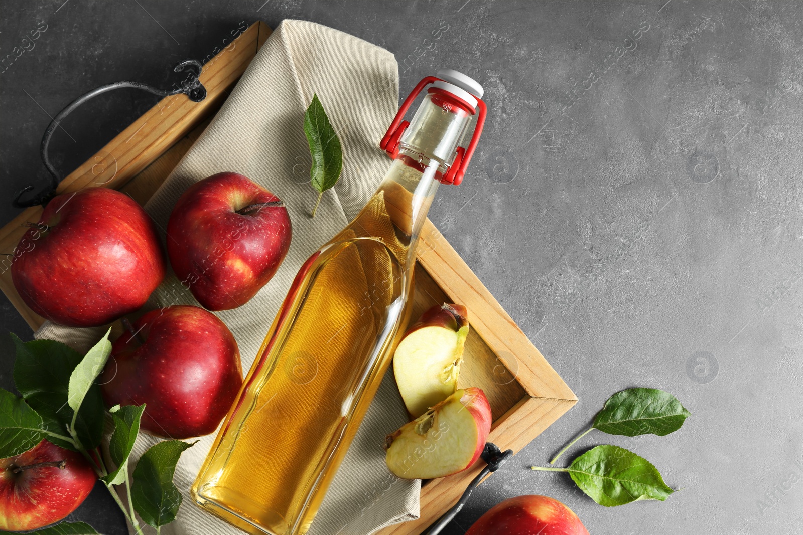 Photo of Flat lay composition with delicious apple cider on gray table, space for text