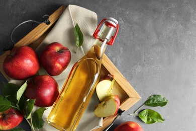 Flat lay composition with delicious apple cider on gray table, space for text