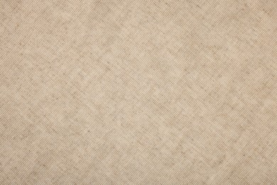 Photo of Texture of natural burlap fabric as background, top view