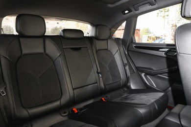 Clean leather seats inside of modern black car