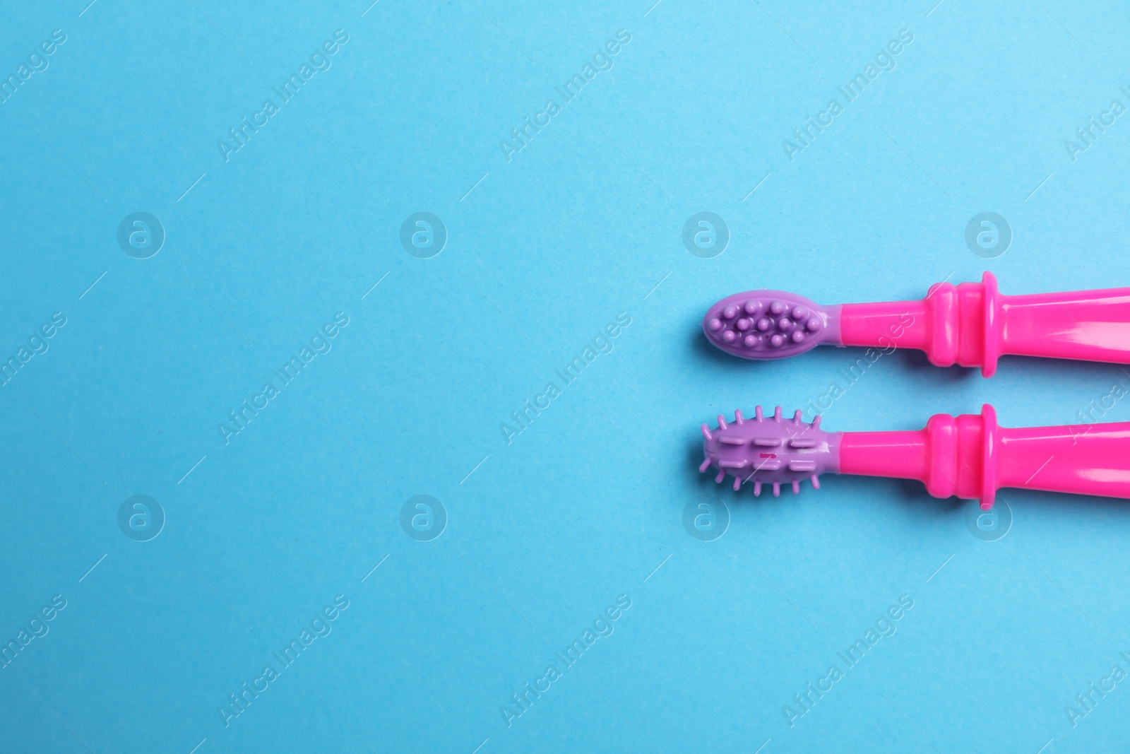 Photo of Manual toothbrushes for children on color background, top view with space for text