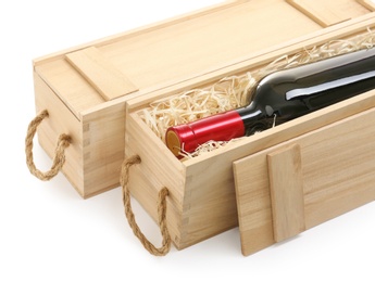Photo of Wooden crates with expensive wine isolated on white, closeup