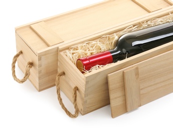 Wooden crates with expensive wine isolated on white, closeup