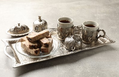 Photo of Tasty chocolate halva served on light grey table