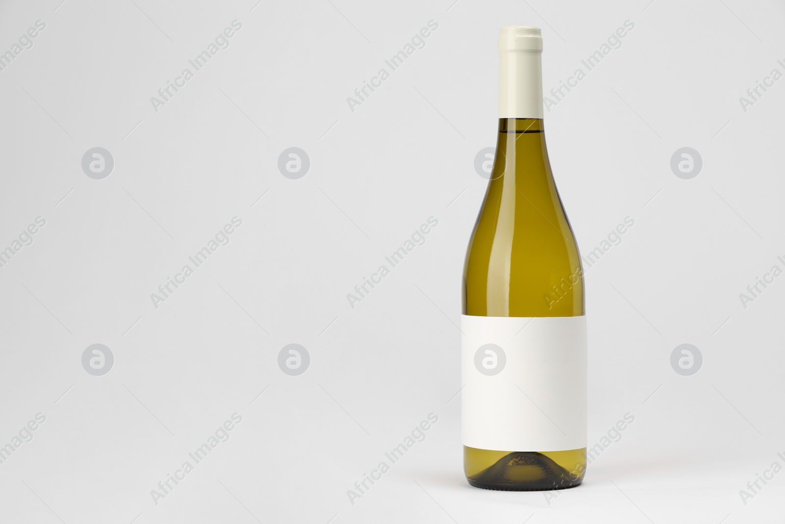 Photo of Bottle of tasty wine on white background, space for text