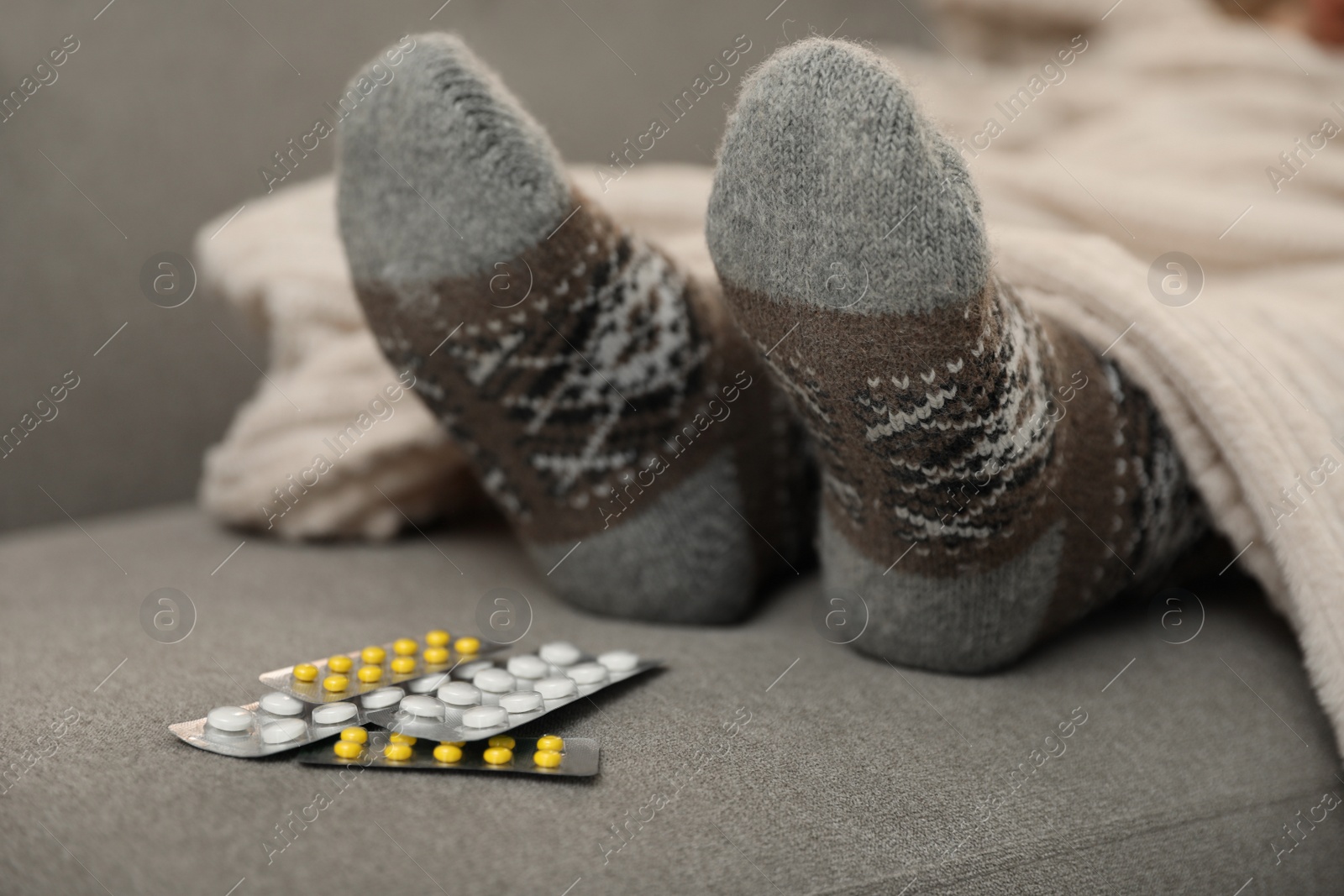 Photo of Mature woman and cold remedies on sofa, closeup. Dangerous virus