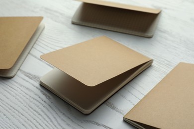 Photo of Kraft planners on white wooden table, closeup