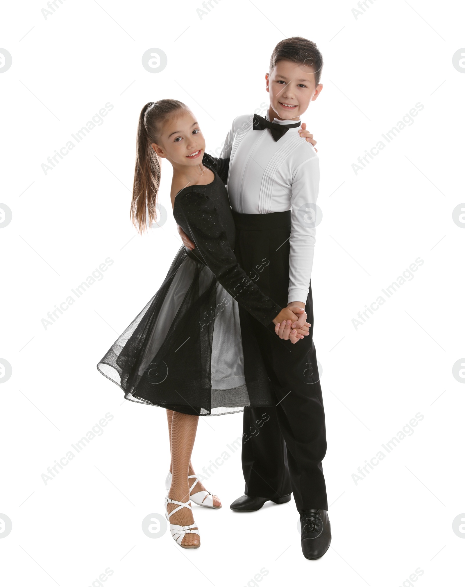 Photo of Beautifully dressed couple of kids dancing on white background