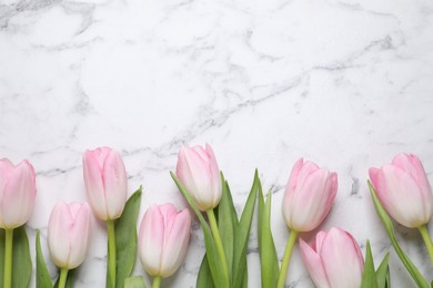 Photo of Beautiful tulips  on white marble table, flat lay. Space for text