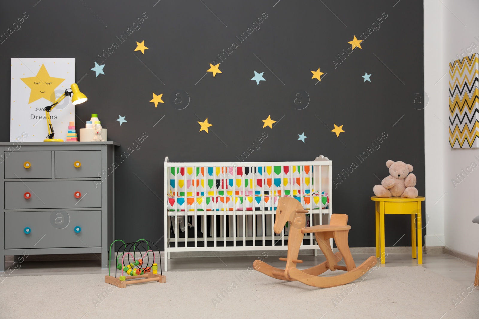 Photo of Cute baby room interior with modern crib and rocking horse