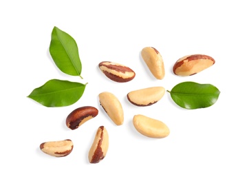 Photo of Composition with Brazil nuts and leaves on white background, top view