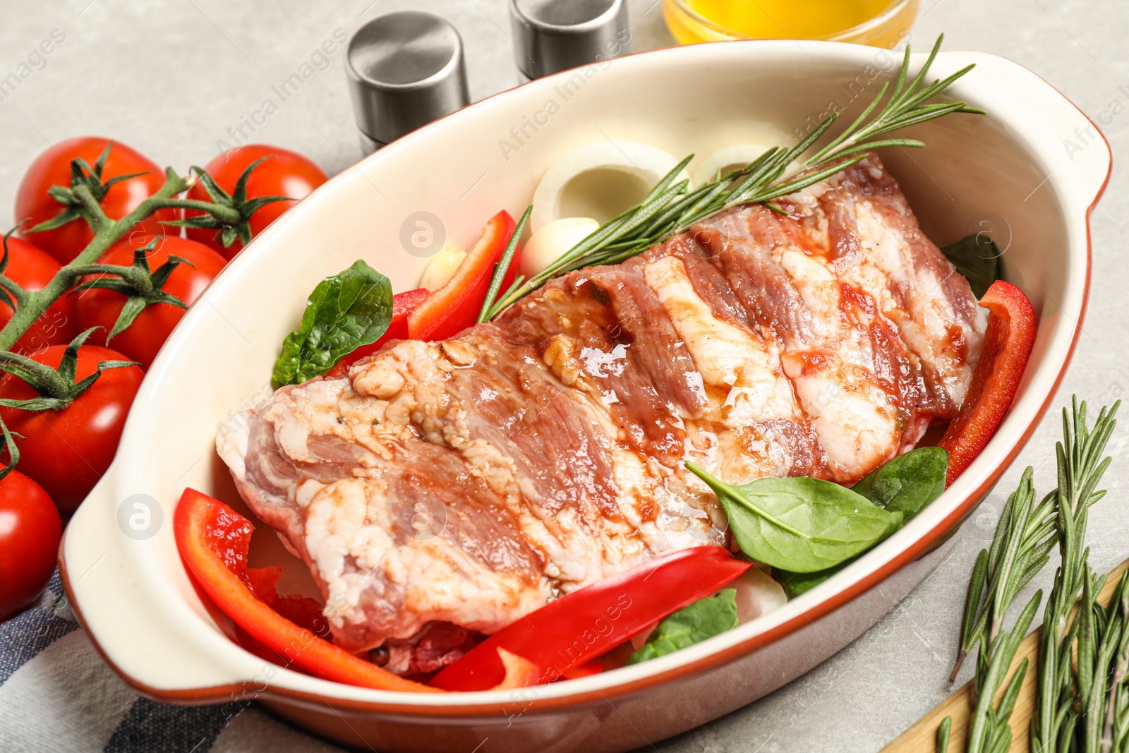 Photo of Raw spare ribs with garnish on light table, closeup