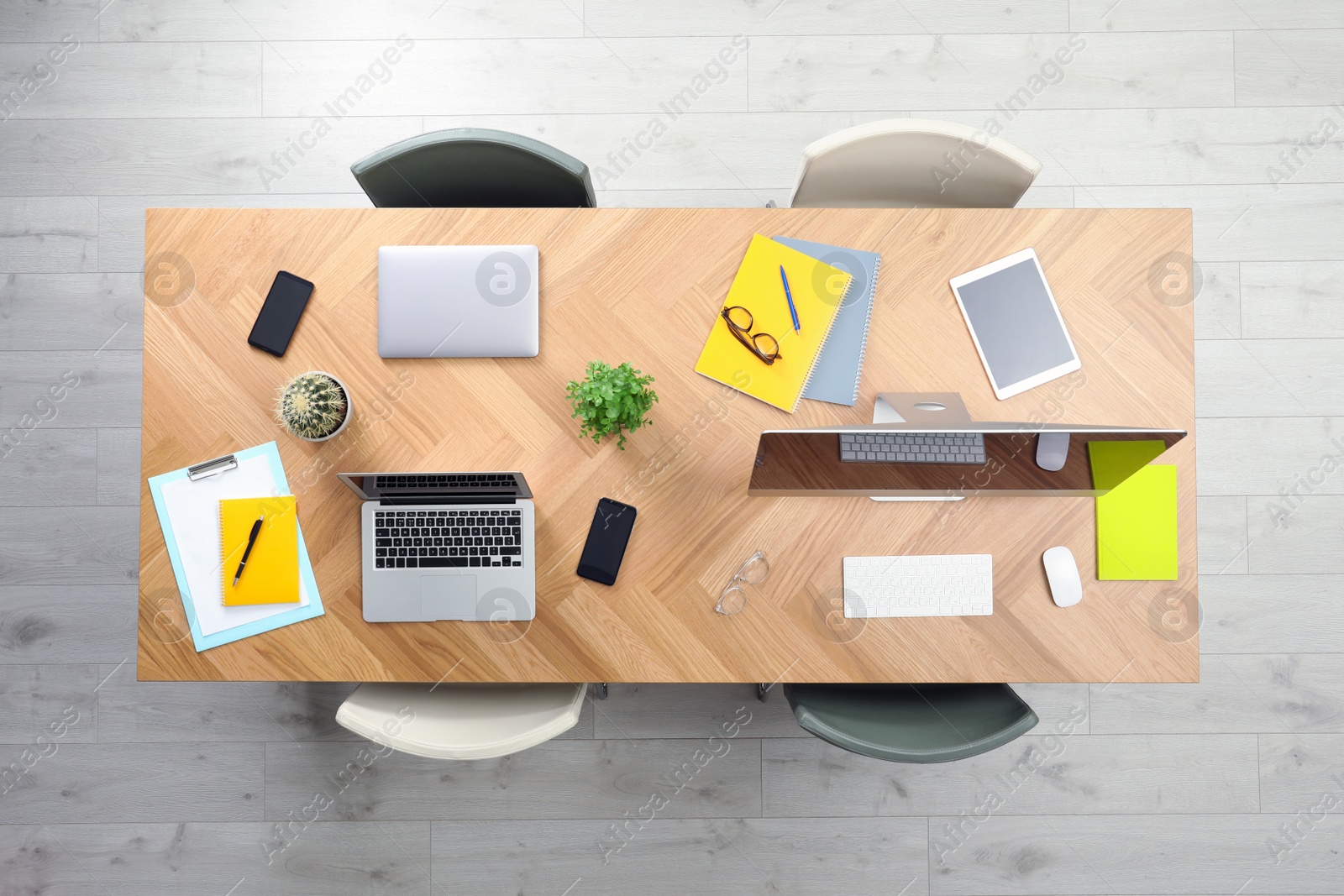 Photo of Modern office table with devices and chairs, top view