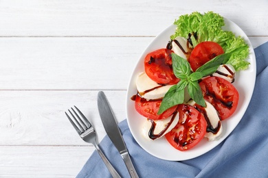 Photo of Plate with delicious fresh salad on table, top view