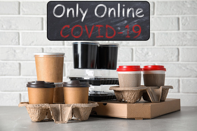 Image of Various takeout containers on table. Online food delivery service