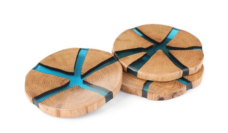 Stylish wooden cup coasters on white background