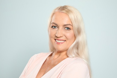 Photo of Portrait of mature woman with beautiful face on grey background