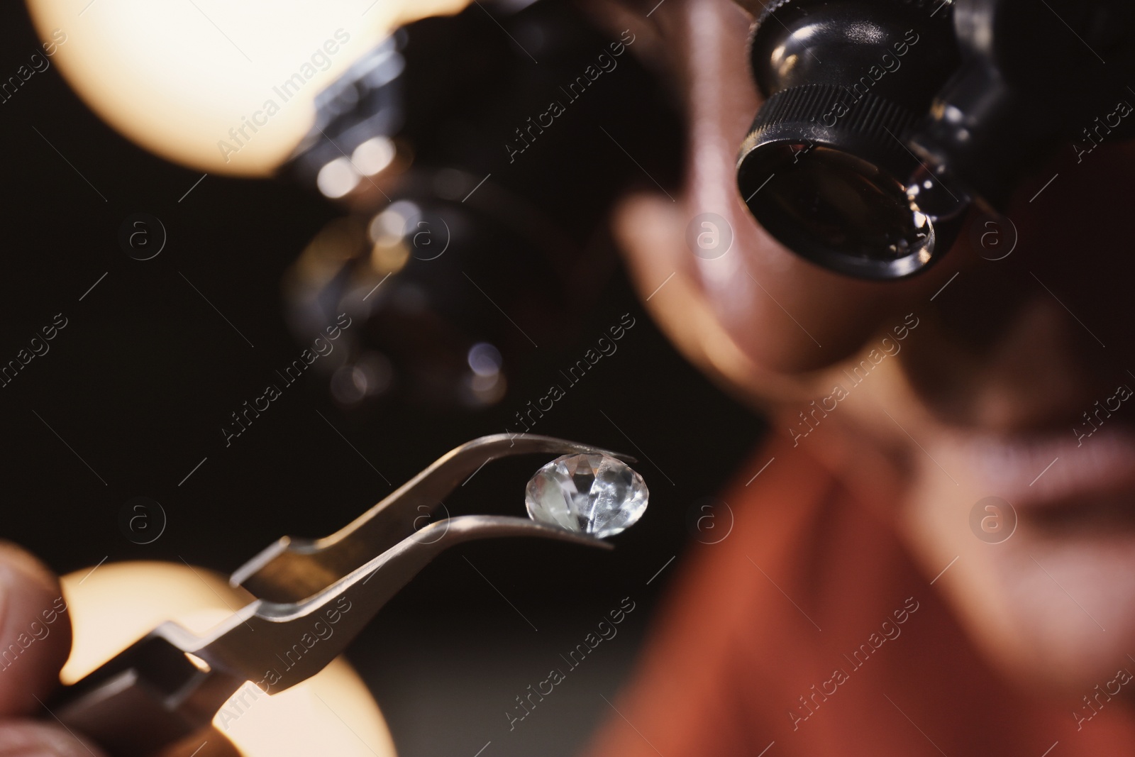 Photo of Professional jeweler evaluating beautiful gemstone, closeup view