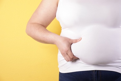 Overweight woman on color background, closeup. Space for text