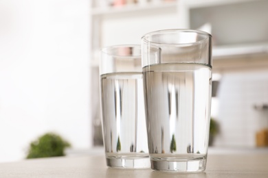 Glasses of fresh water on table indoors