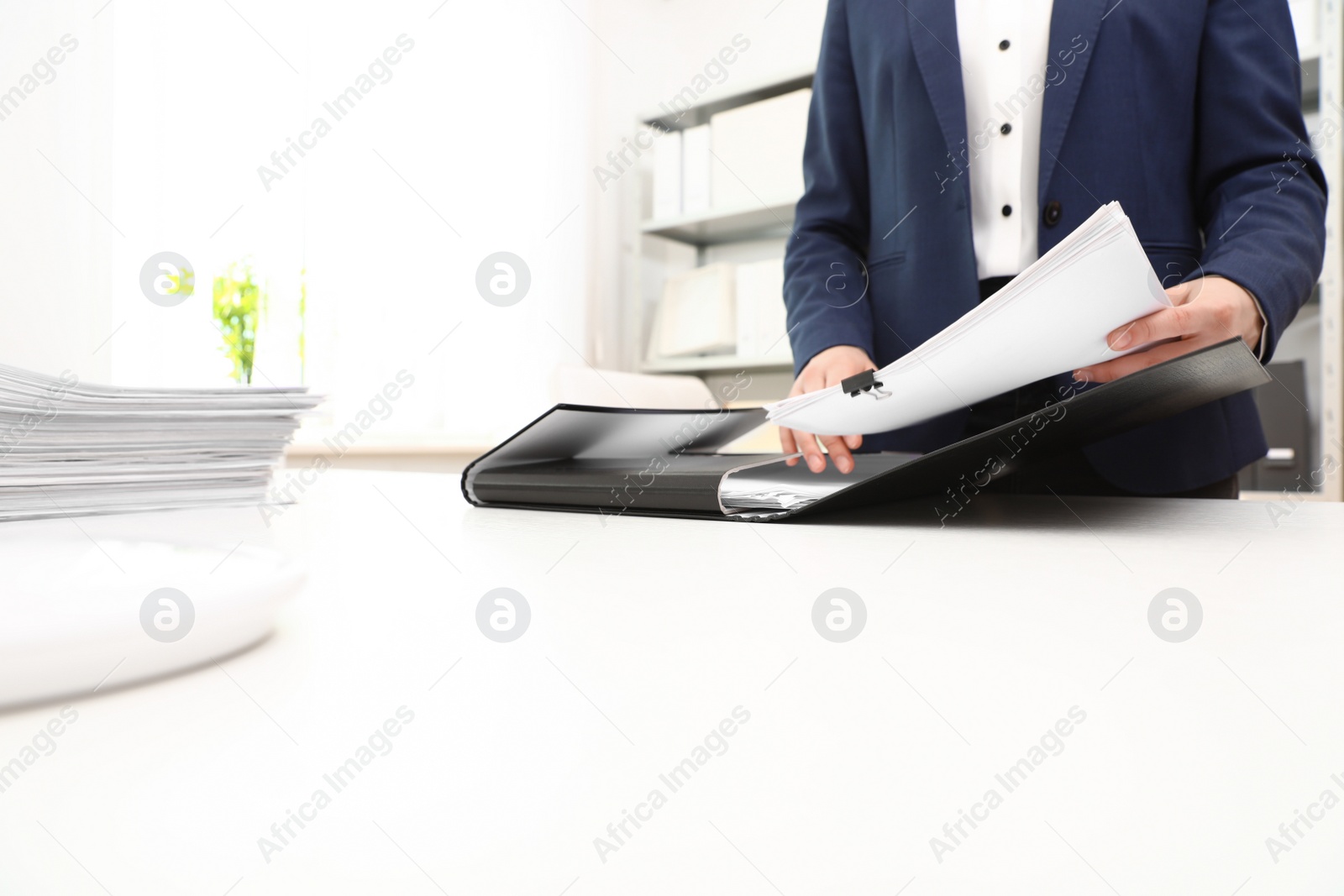 Photo of Woman working with documents at table in office, closeup