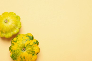 Fresh ripe pattypan squashes on beige background, flat lay. Space for text