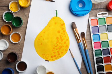 Flat lay composition with child's painting of pear on wooden table