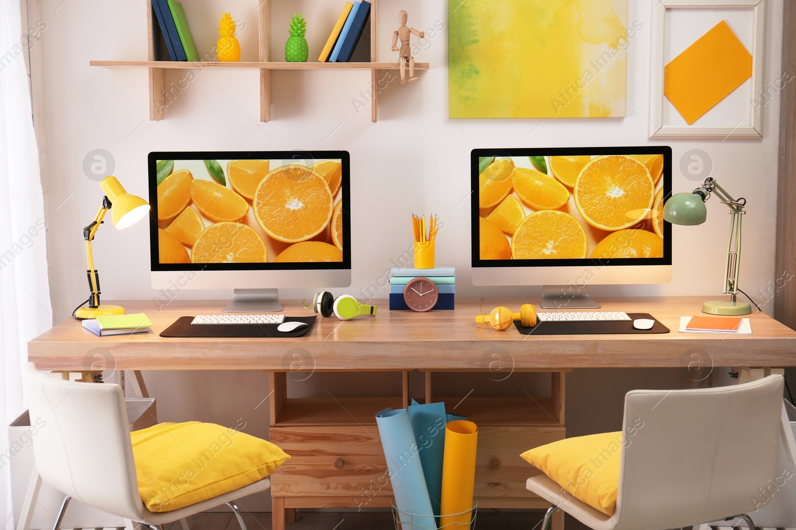 Photo of Modern workplace with large desk and computers in room. Stylish interior