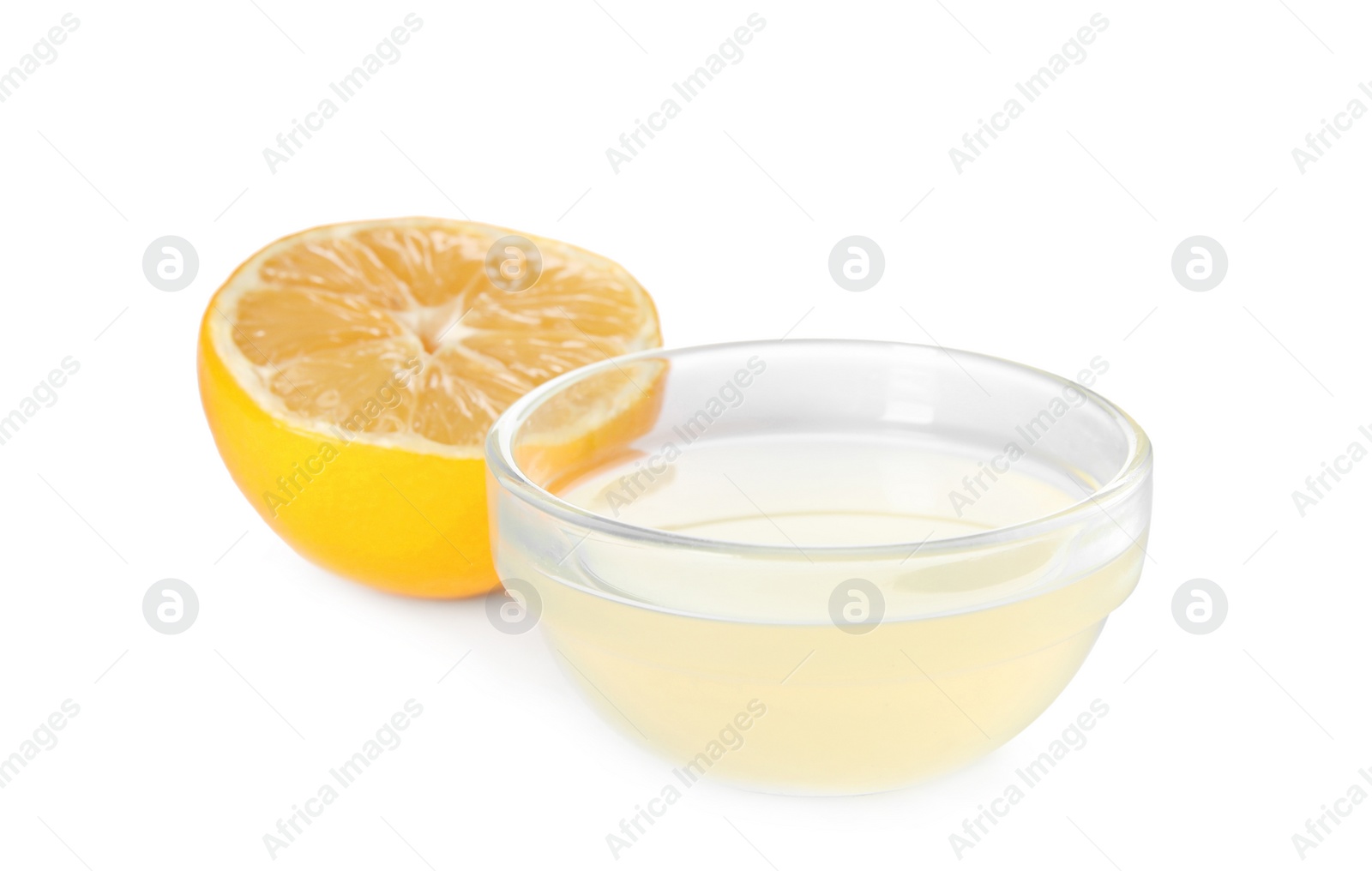 Photo of Freshly squeezed juice and half of lemon on white background