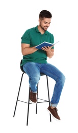 Handsome young man reading book on white background