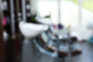 Photo of Blurred view of modern hairdressing salon interior