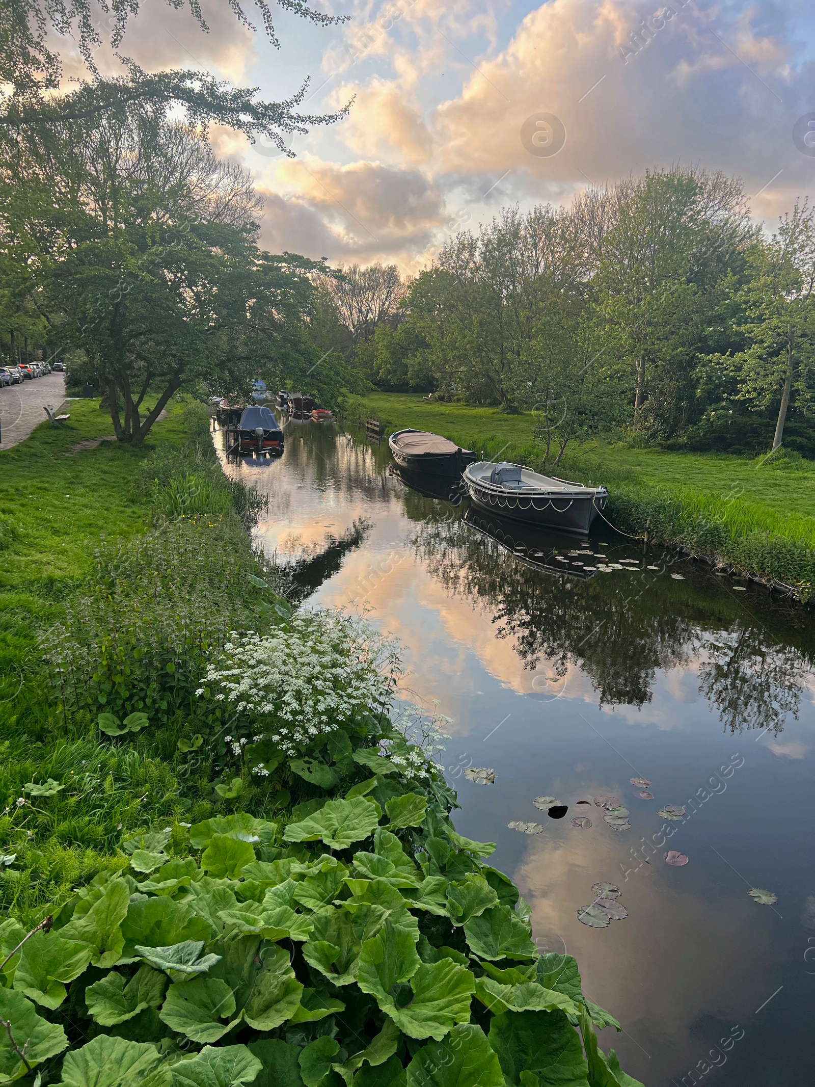 Photo of Beautiful view of canal with moored boats outdoors on spring day