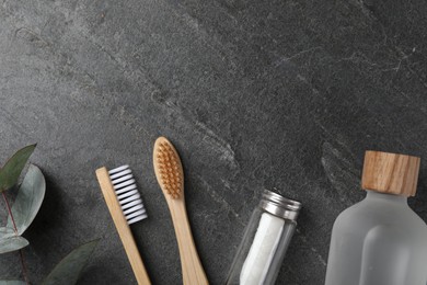 Photo of Flat lay composition with bamboo toothbrushes on black table, space for text