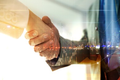 Image of Deal or partnership concept. Multiple exposure with cityscape, charts and photo of businesspeople shaking hands