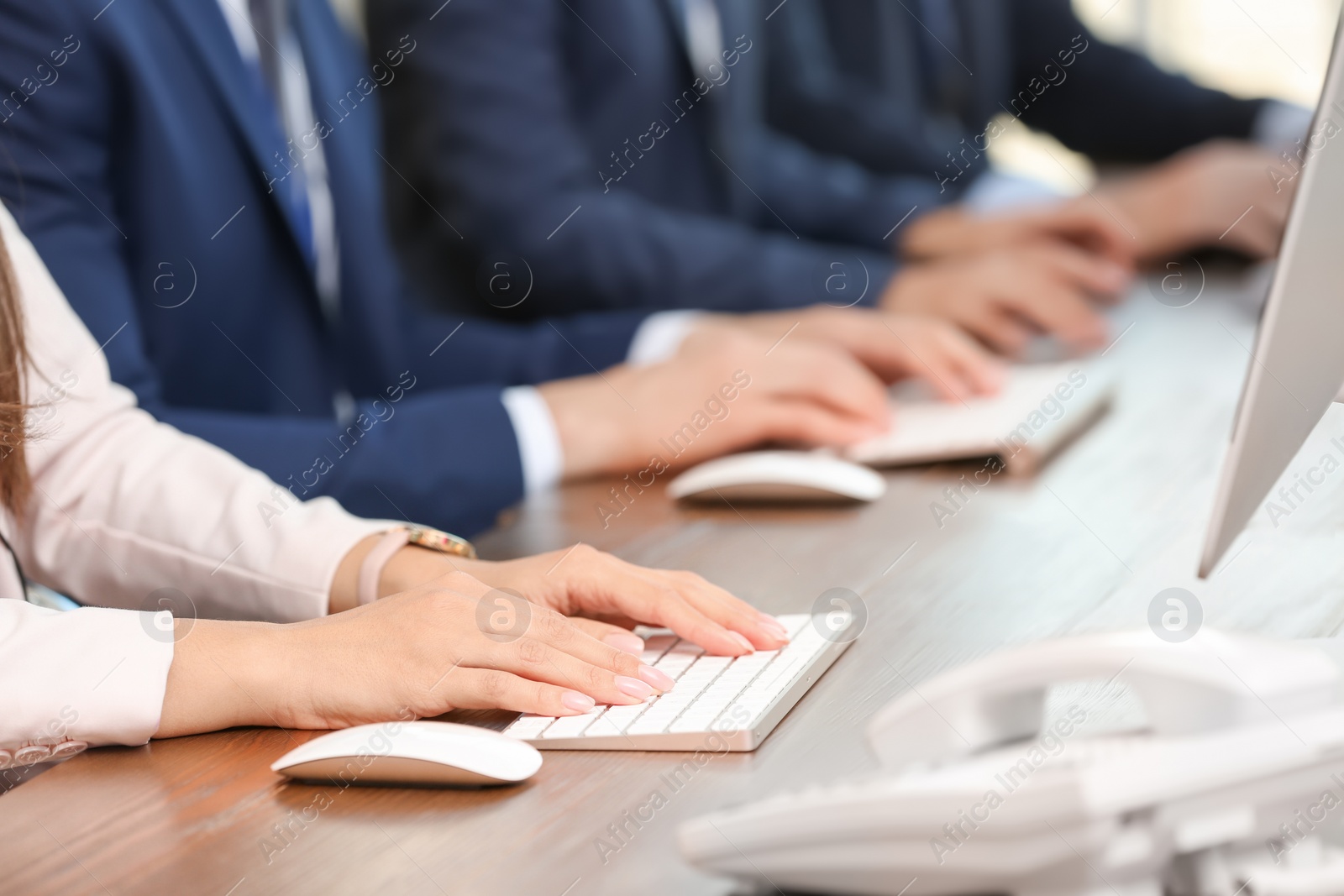 Photo of Technical support operators using computers at workplace, closeup