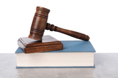 Wooden gavel, sound block and book on light table against white background