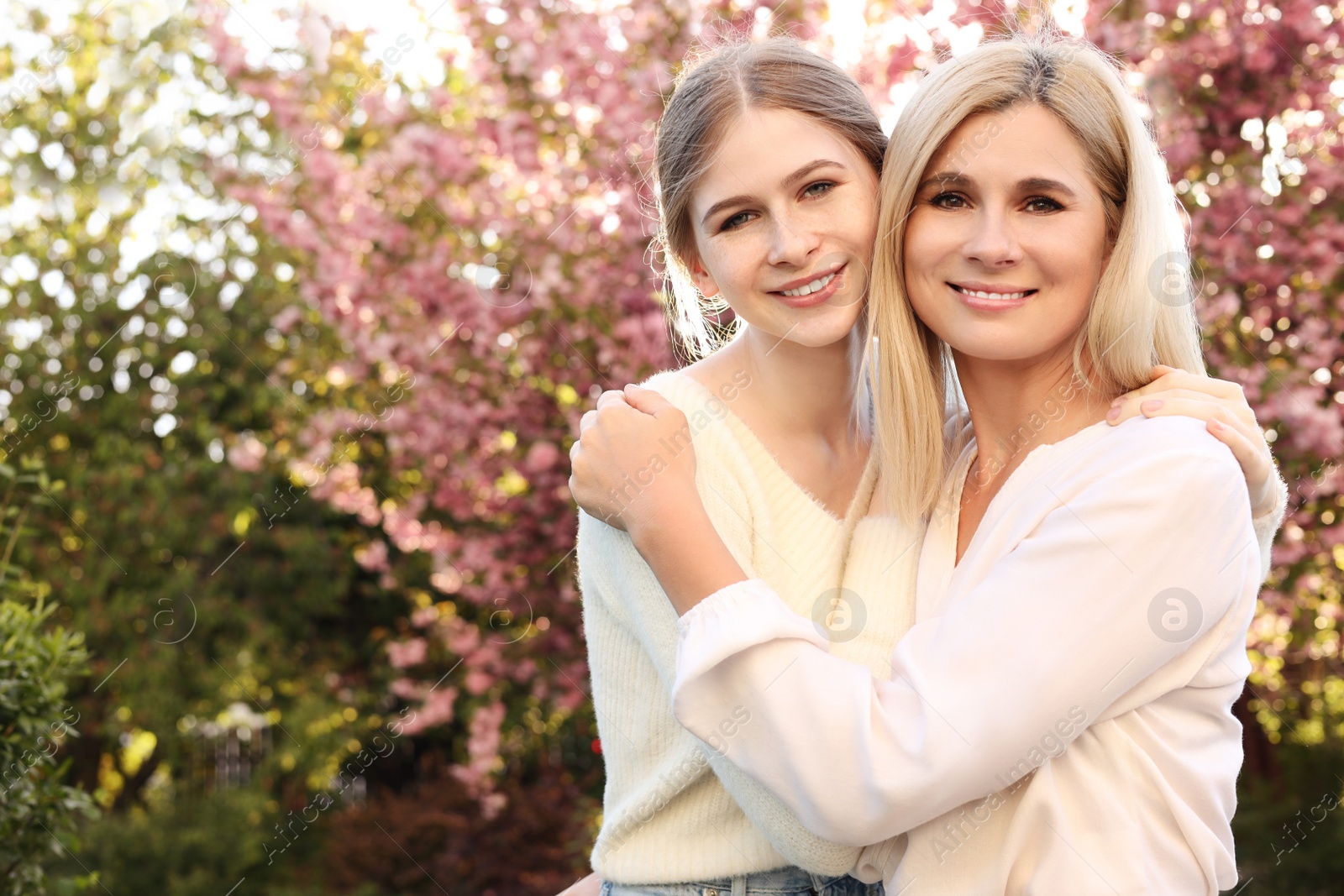 Photo of Happy mother with her daughter spending time together in park on sunny day