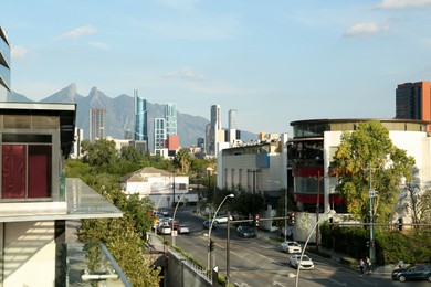 Picturesque view of mountains and city with skyscrapers