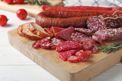 Cutting board with different sliced meat products served on table