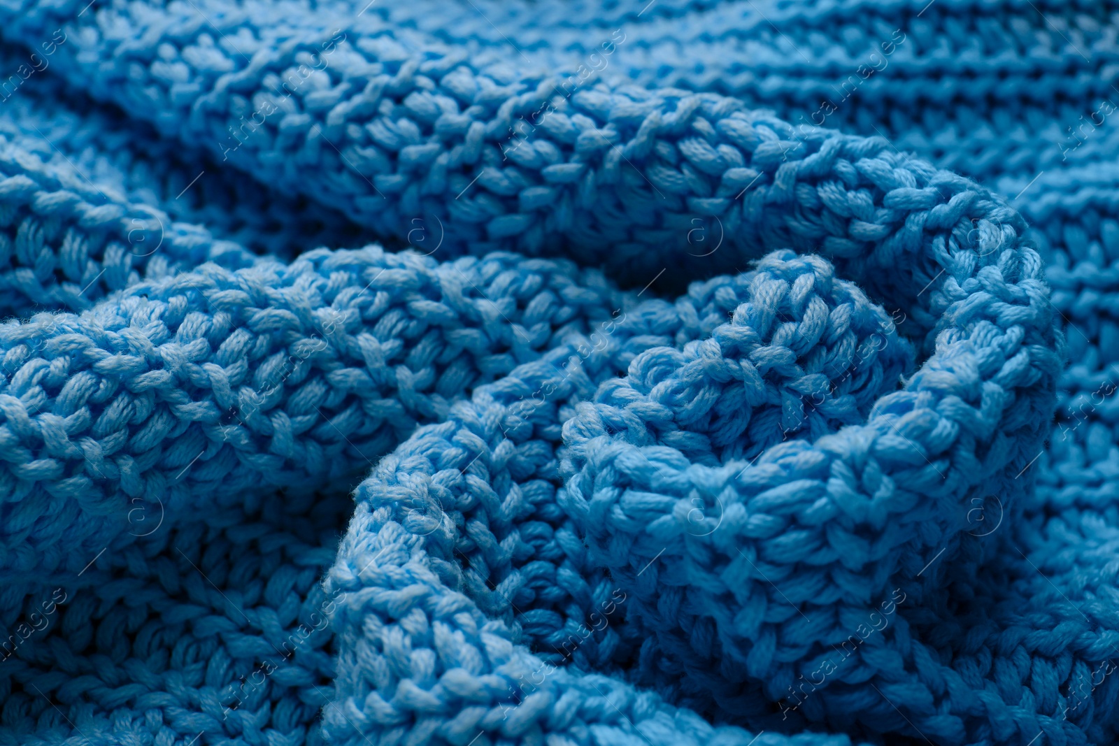 Photo of Beautiful light blue knitted fabric as background, closeup