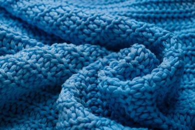 Photo of Beautiful light blue knitted fabric as background, closeup