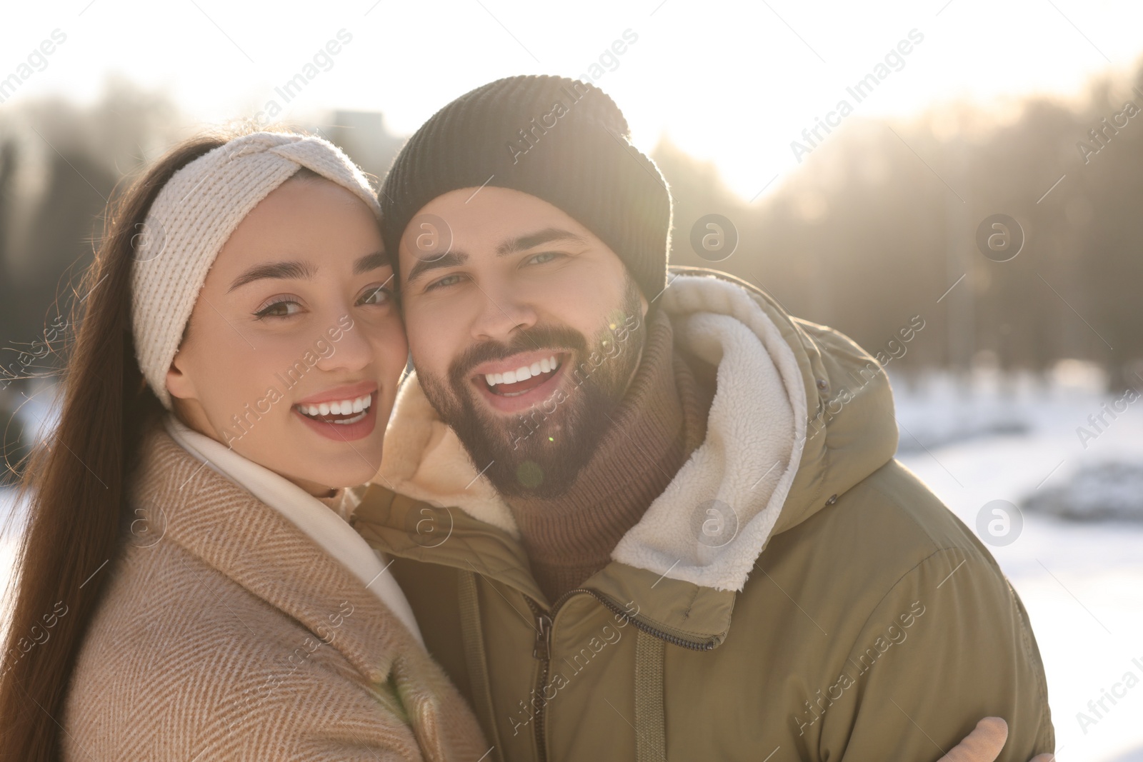 Photo of Beautiful happy couple in snowy park on winter day