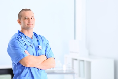 Photo of Portrait of medical assistant with stethoscope in hospital. Space for text