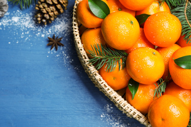 Flat lay composition with tangerines on blue wooden background. Space for text