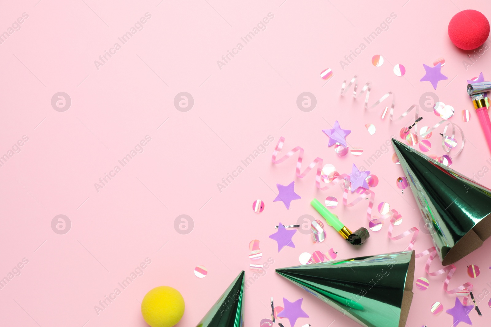 Photo of Flat lay composition with hats and other festive items on pink background, space for text. Surprise party