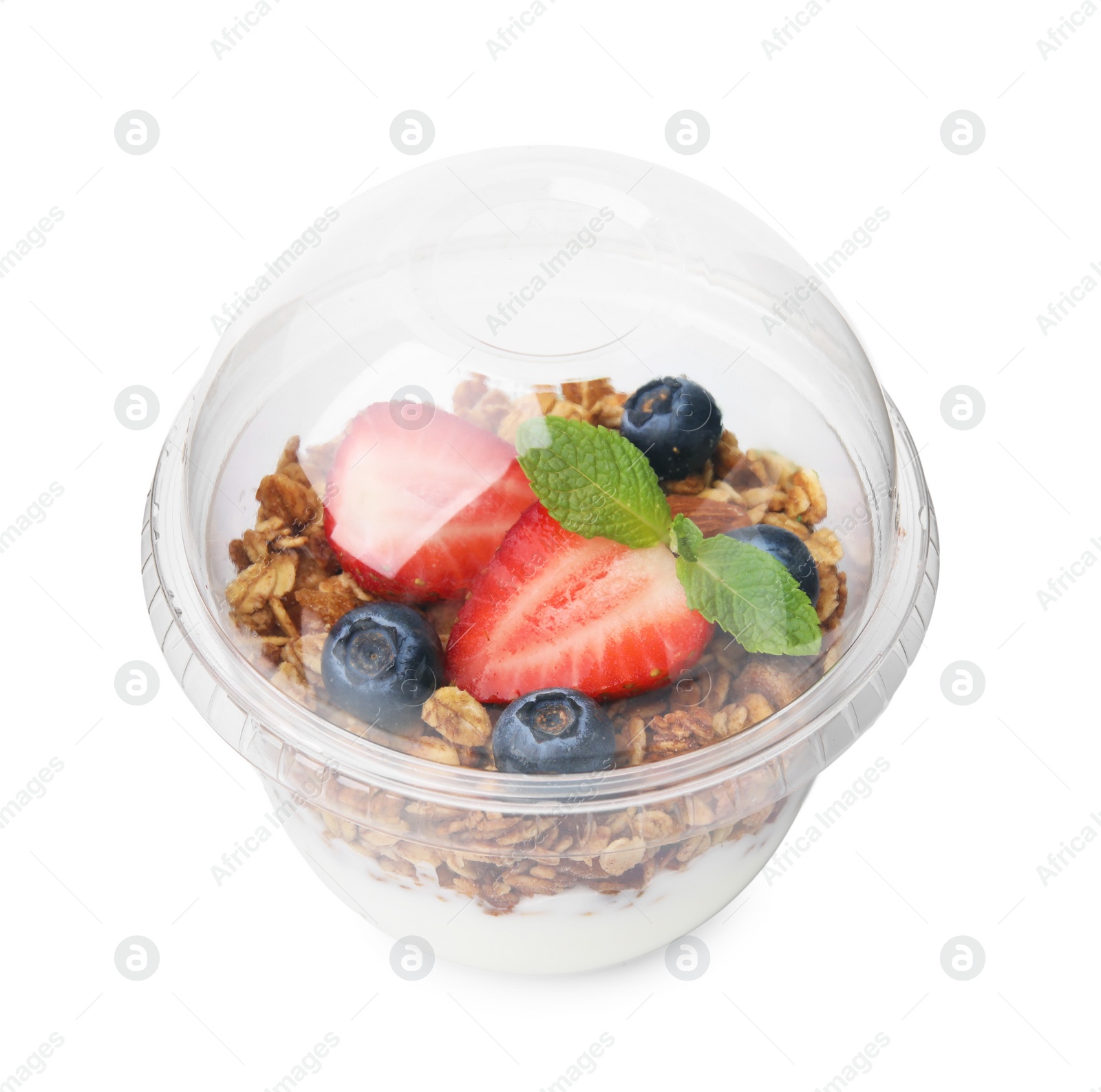 Photo of Tasty granola with berries and yogurt in plastic cup isolated on white