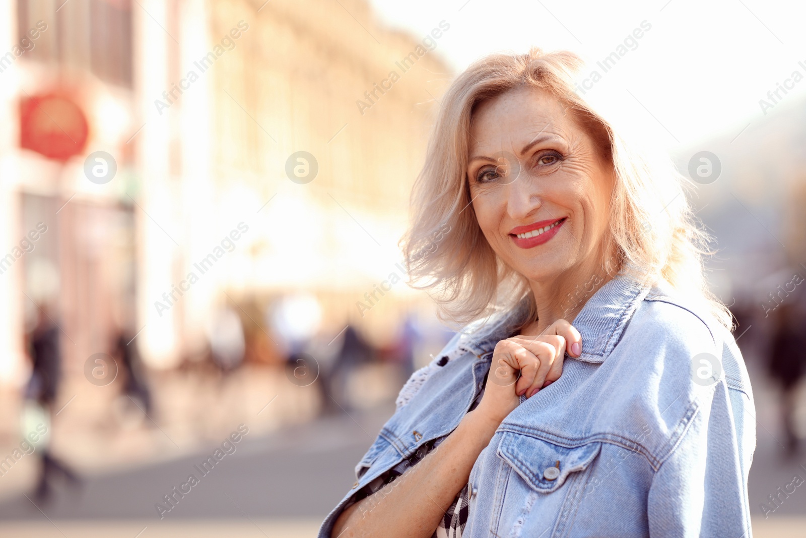 Photo of Portrait of happy mature woman on city street