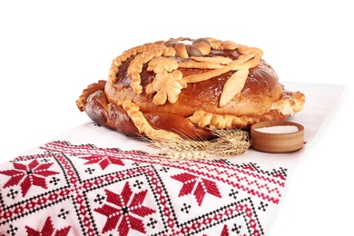Photo of Rushnyk with korovai on white background. Ukrainian bread and salt welcoming tradition