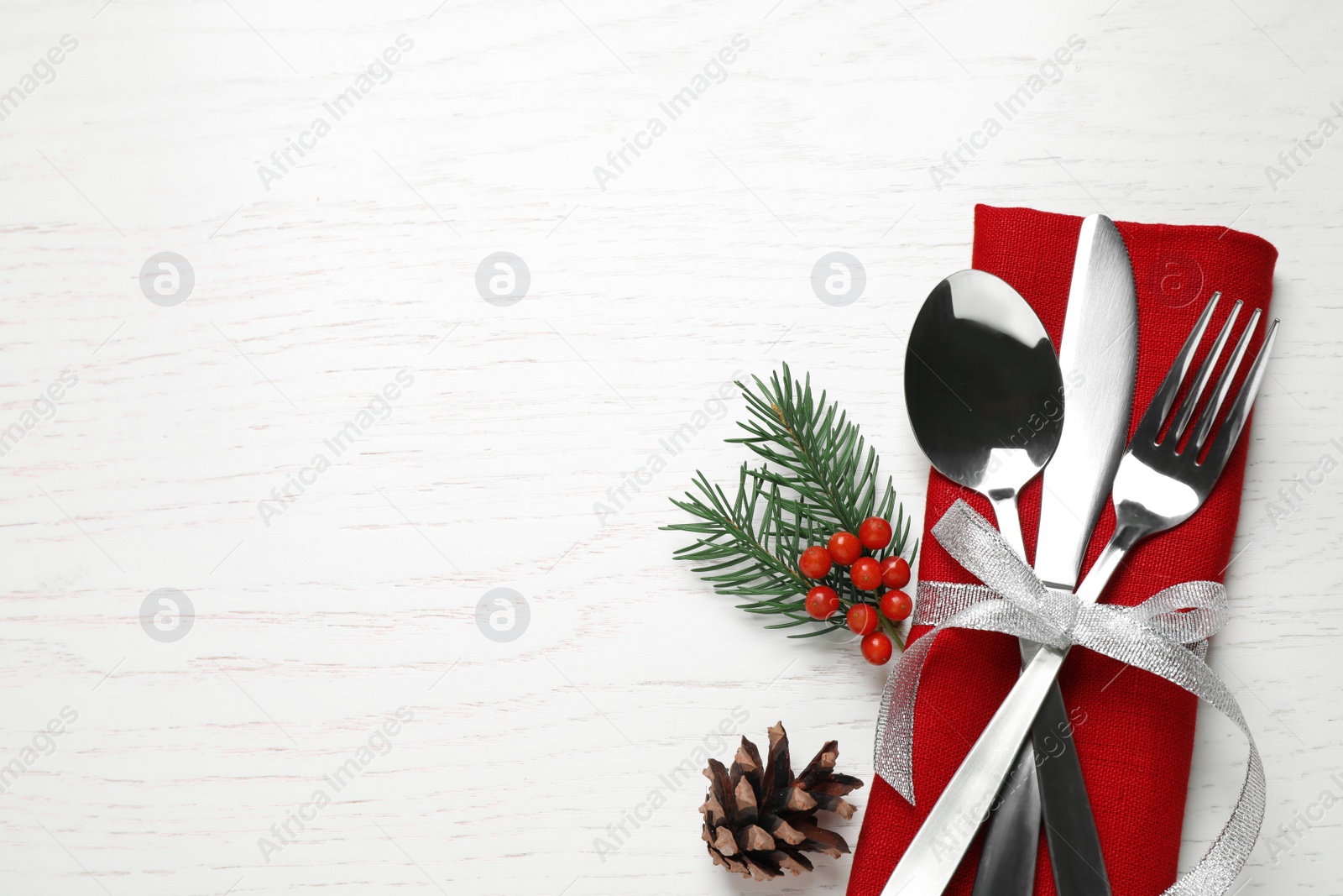 Photo of Cutlery set on white wooden table, top view. Space for text